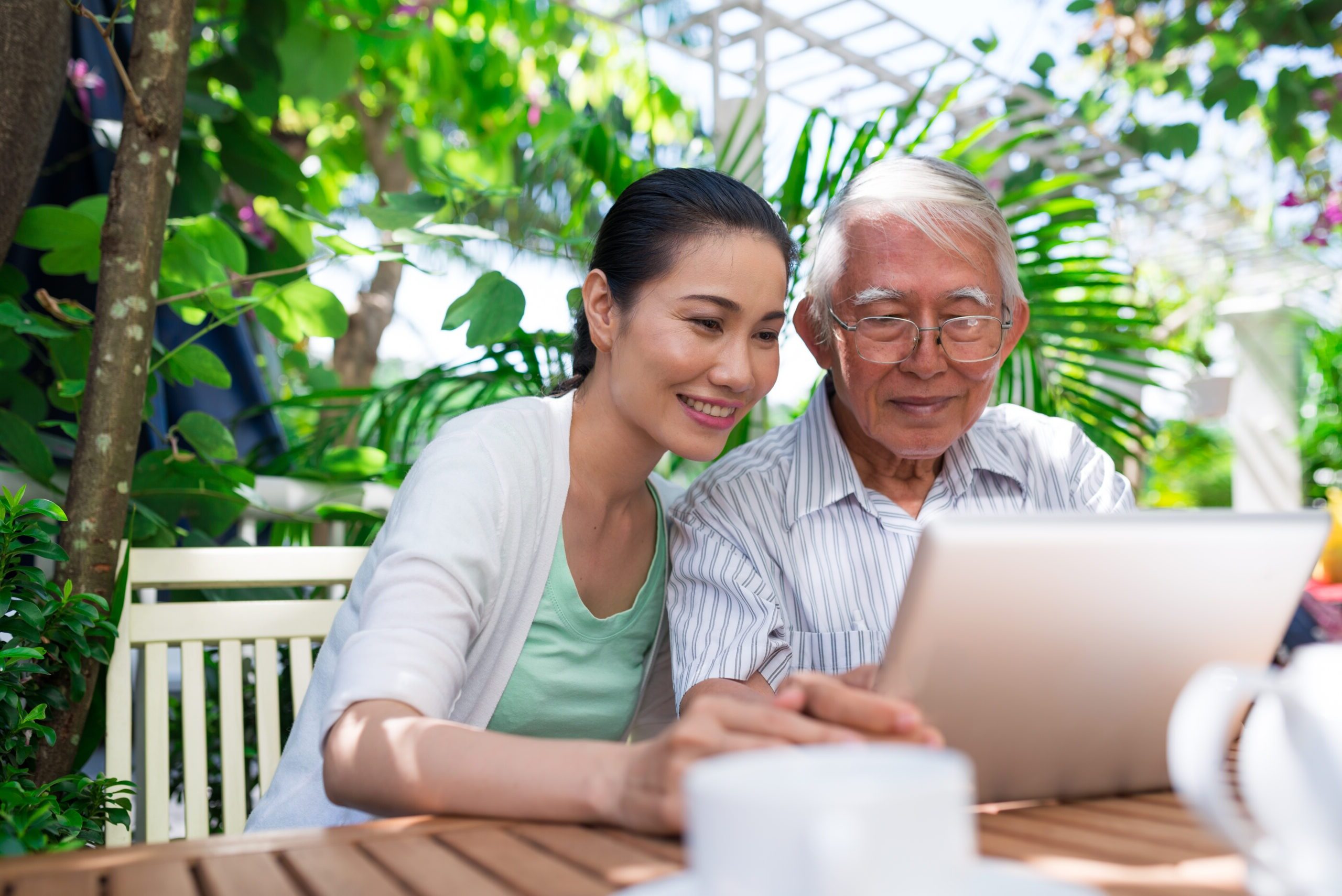 father and daughter looking at a computer