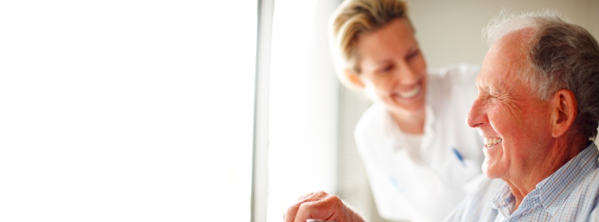 resident laughing with a healthcare professional