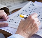 Person doing a crossword memory puzzle