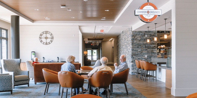 group of residents sitting down next to a coffee shop