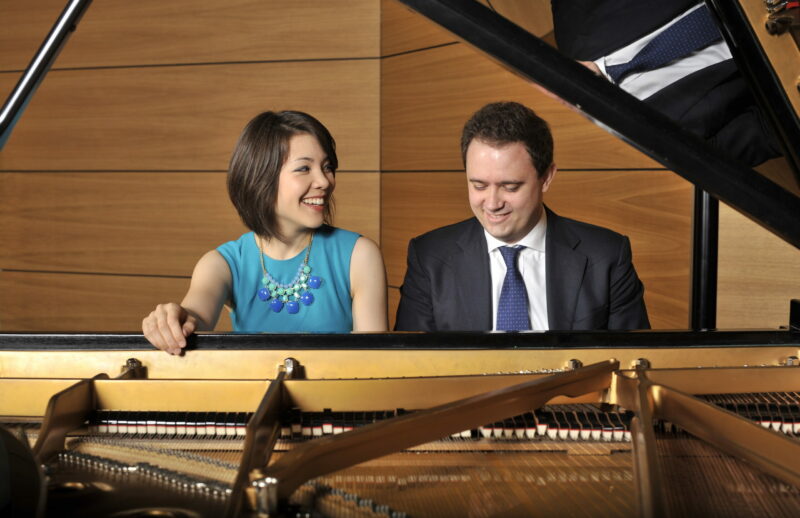 two pianists playing piano